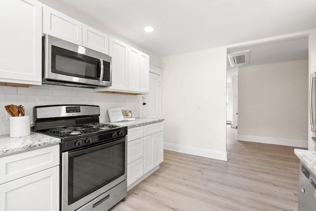 3 Regent Cir Unit 3, Boston, MA 02130 - kitchen with stainless steel appliances, baseboards, backsplash, light wood finished floors, and white cabinetry