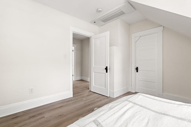 3 Regent Cir Unit 3, Boston, MA 02130 - unfurnished bedroom featuring wood finished floors, baseboards, and lofted ceiling
