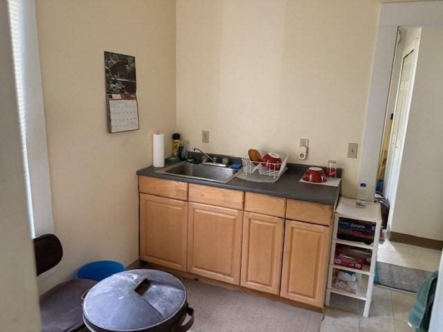 613 School St, Lowell, MA 01851 - kitchen featuring a sink, dark countertops, and light brown cabinetry