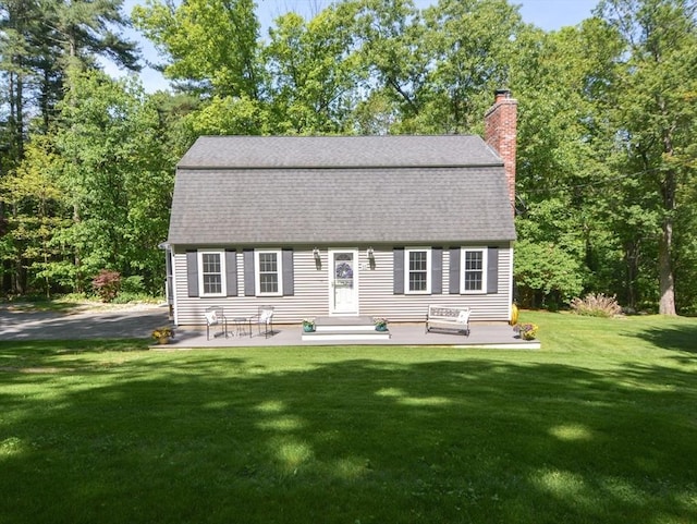 33 Rockmeadow Rd, Uxbridge, MA 01569 - colonial inspired home featuring a gambrel roof, roof with shingles, a front yard, and a chimney