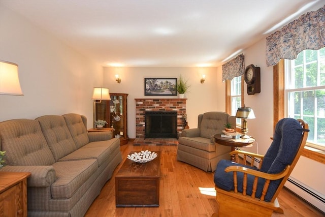 33 Rockmeadow Rd, Uxbridge, MA 01569 - living area with a baseboard radiator, hardwood / wood-style flooring, and a brick fireplace