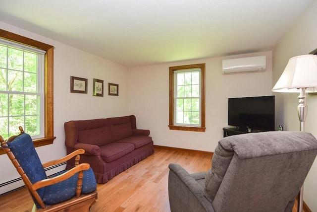 33 Rockmeadow Rd, Uxbridge, MA 01569 - living area with a wall unit AC, wood finished floors, healthy amount of natural light, and baseboards