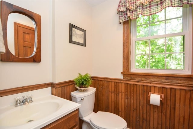 33 Rockmeadow Rd, Uxbridge, MA 01569 - bathroom with a wainscoted wall, toilet, vanity, plenty of natural light, and wooden walls