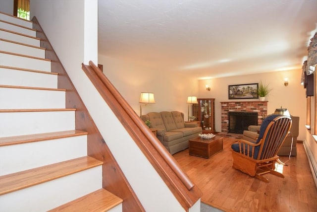 33 Rockmeadow Rd, Uxbridge, MA 01569 - living area with stairs, wood-type flooring, and a brick fireplace