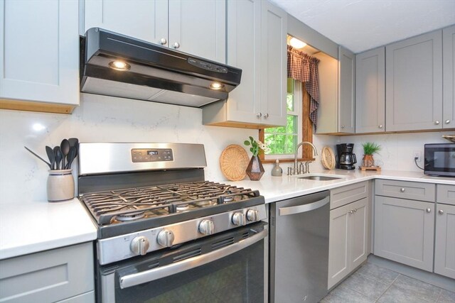 33 Rockmeadow Rd, Uxbridge, MA 01569 - kitchen with stainless steel appliances, exhaust hood, gray cabinetry, a sink, and light countertops