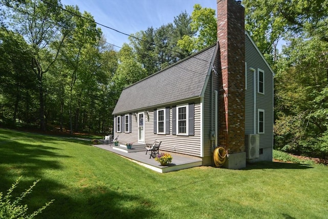 33 Rockmeadow Rd, Uxbridge, MA 01569 - view of property exterior with a chimney, a yard, roof with shingles, and ac unit