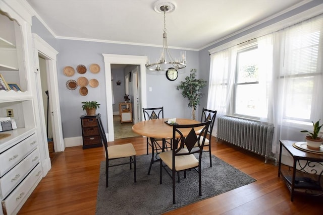 419-421 Court St, New Bedford, MA 02740 - dining area with radiator heating unit, a chandelier, crown molding, and wood finished floors