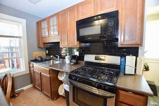 419-421 Court St, New Bedford, MA 02740 - kitchen with black microwave, stainless steel gas range oven, a sink, and tasteful backsplash