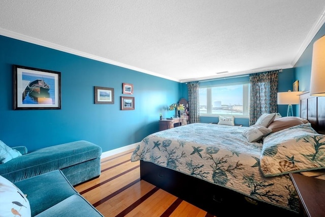 bedroom featuring crown molding, a textured ceiling, and hardwood / wood-style flooring