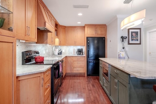 kitchen featuring sink, backsplash, black appliances, light stone countertops, and dark wood-type flooring