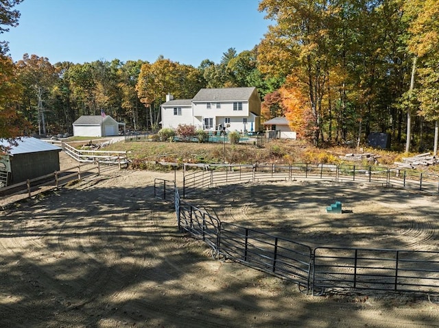 view of front of home with a rural view