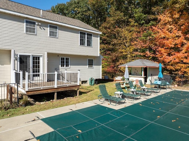 back of property featuring a patio area, a lawn, and a wooden deck