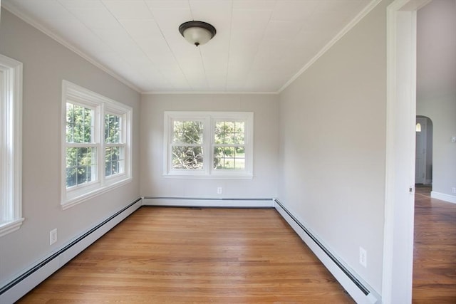 329 Read St, Somerset, MA 02726 - spare room featuring baseboard heating, ornamental molding, plenty of natural light, and arched walkways