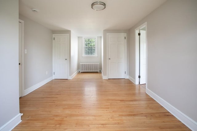 329 Read St, Somerset, MA 02726 - unfurnished room featuring radiator, light wood-style flooring, and a smoke detector