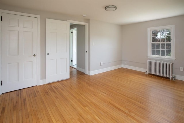 329 Read St, Somerset, MA 02726 - unfurnished bedroom featuring radiator heating unit and light wood-type flooring