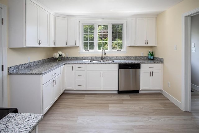 329 Read St, Somerset, MA 02726 - kitchen with dishwasher, white cabinetry, light stone countertops, and light wood finished floors