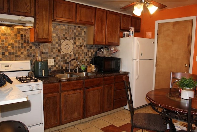 kitchen with tasteful backsplash, a ceiling fan, a sink, white appliances, and under cabinet range hood