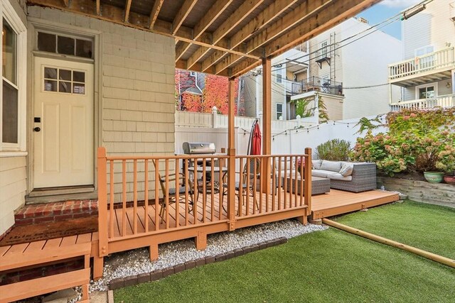 wooden deck featuring grilling area and an outdoor living space