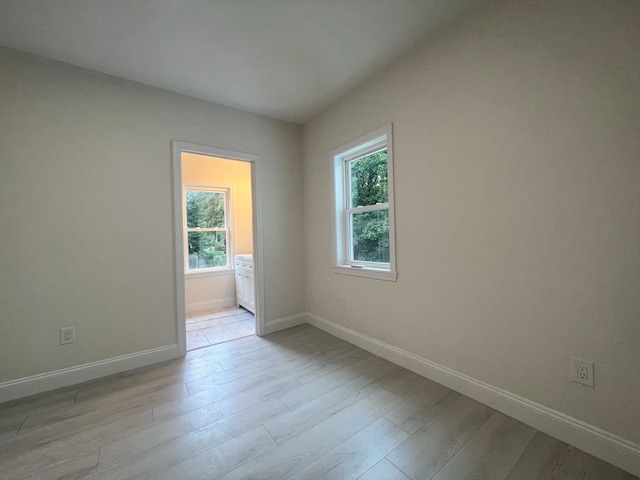 unfurnished room featuring light hardwood / wood-style flooring and a wealth of natural light