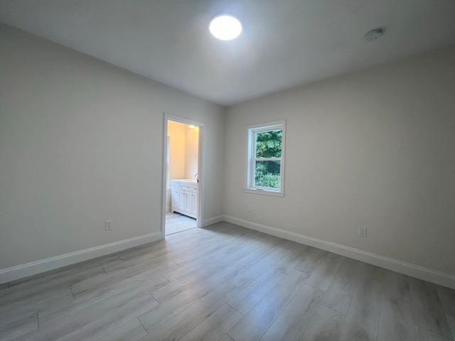 spare room with light hardwood / wood-style flooring