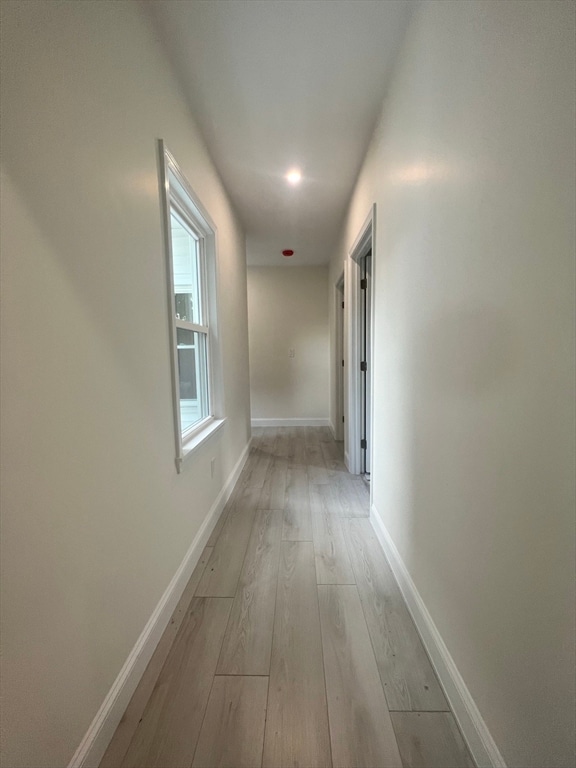 hall with light hardwood / wood-style flooring