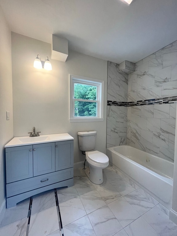 full bathroom with tiled shower / bath combo, vanity, and toilet