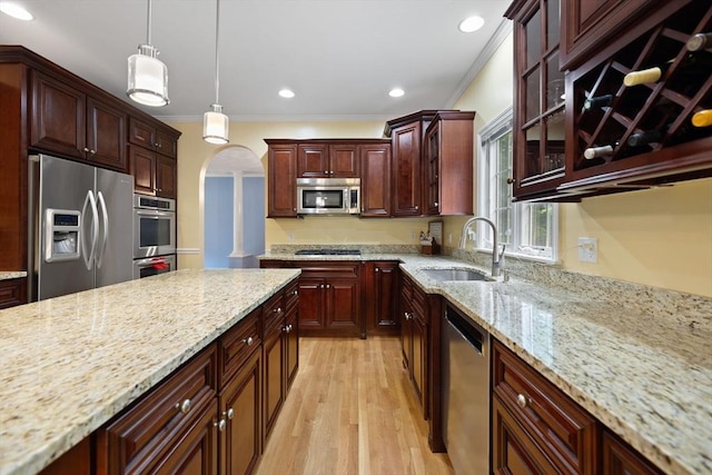 1 Eleanor Dr, Wilmington, MA 01887 - kitchen featuring stainless steel appliances, ornamental molding, a sink, arched walkways, and pendant lighting