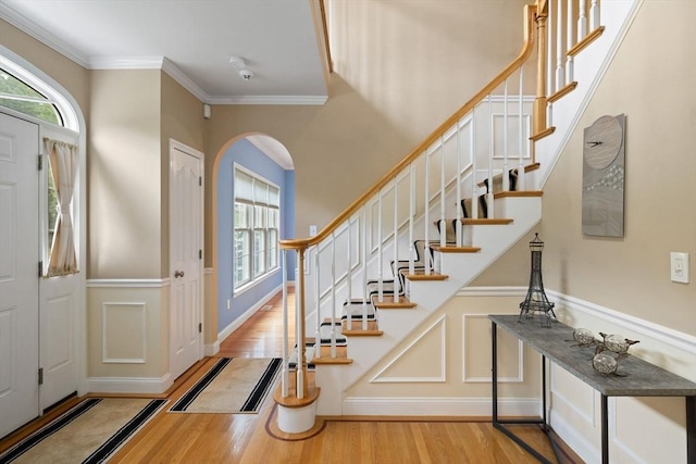 1 Eleanor Dr, Wilmington, MA 01887 - foyer entrance featuring wood finished floors, arched walkways, stairway, and crown molding