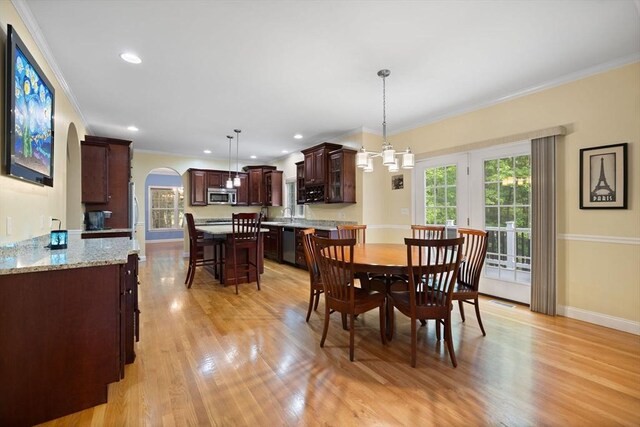 1 Eleanor Dr, Wilmington, MA 01887 - dining space with plenty of natural light, arched walkways, crown molding, light wood finished floors, and baseboards