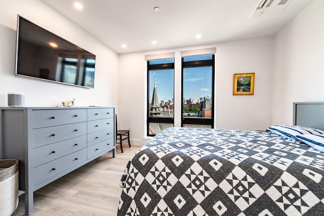 bedroom with access to exterior and light hardwood / wood-style flooring