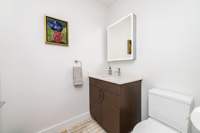 bathroom featuring toilet and vanity