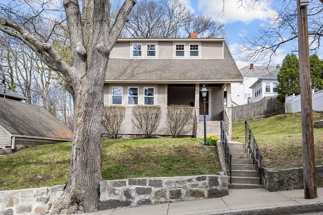 bungalow-style home featuring a chimney, a shingled roof, fence, a porch, and a front yard