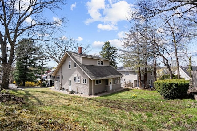 view of property exterior featuring roof with shingles, central AC, a chimney, and a lawn
