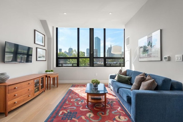 100 Shawmut Ave Unit 202, Boston, MA 02118 - living room with light wood-type flooring, baseboards, a skyline view, and recessed lighting
