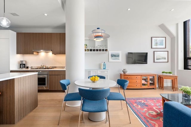 100 Shawmut Ave Unit 202, Boston, MA 02118 - kitchen featuring appliances with stainless steel finishes, light wood-type flooring, modern cabinets, light countertops, and hanging light fixtures