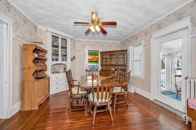 dining room with ornamental molding, dark wood-type flooring, and ceiling fan