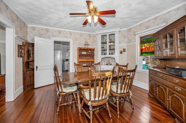 dining area featuring dark wood-type flooring, ceiling fan, and ornamental molding