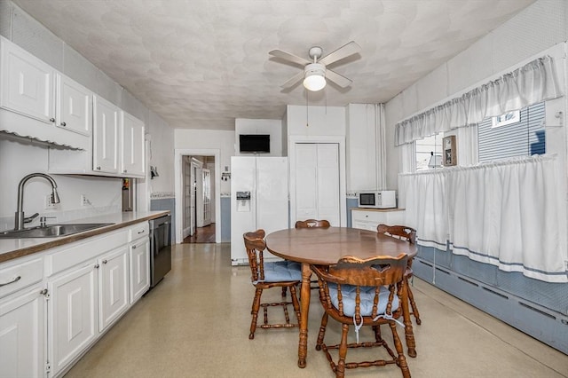 dining room with ceiling fan, a baseboard radiator, and sink