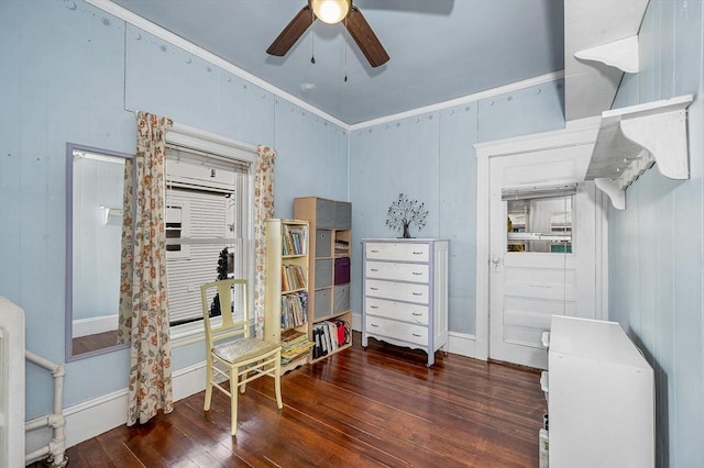 interior space featuring ceiling fan, ornamental molding, and dark hardwood / wood-style flooring