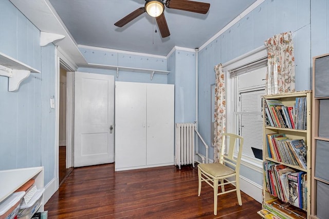 living area featuring ceiling fan, ornamental molding, dark hardwood / wood-style flooring, and radiator