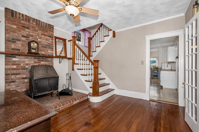 interior space with ornamental molding, hardwood / wood-style floors, and ceiling fan