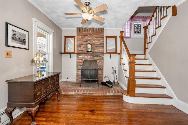 living room with hardwood / wood-style flooring, ceiling fan, ornamental molding, and baseboard heating