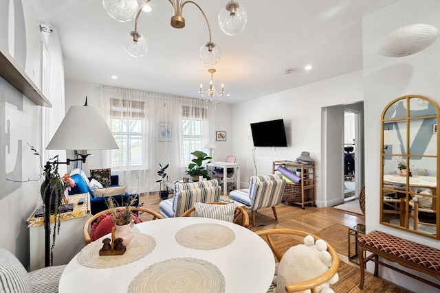 dining room with light hardwood / wood-style flooring and a chandelier