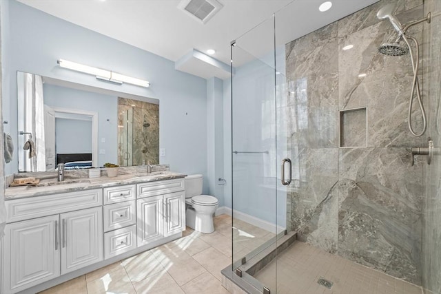 bathroom featuring tile patterned flooring, vanity, toilet, and an enclosed shower