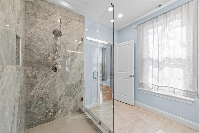 bathroom with tile patterned flooring and a shower with shower door