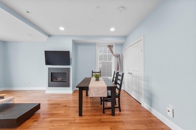 dining space with light hardwood / wood-style flooring