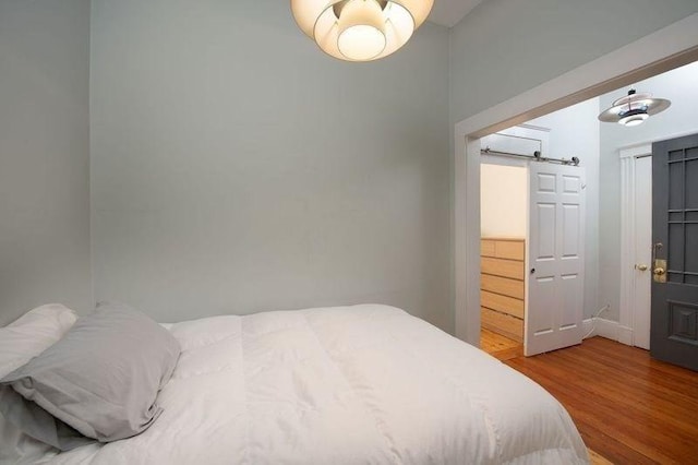 1411 Washington St Unit 7, Boston, MA 02118 - bedroom featuring wood finished floors and a barn door