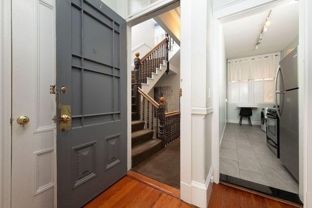 1411 Washington St Unit 7, Boston, MA 02118 - entryway featuring stairway, baseboards, and wood finished floors