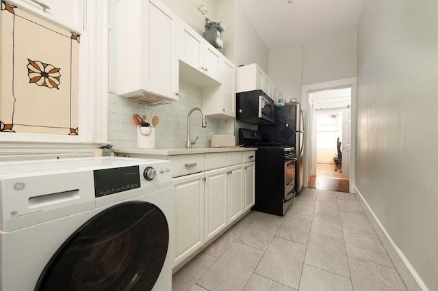 1411 Washington St Unit 7, Boston, MA 02118 - kitchen featuring range with gas cooktop, black microwave, a sink, light countertops, and decorative backsplash