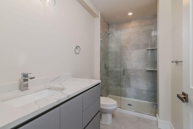 bathroom with walk in shower, vanity, and toilet